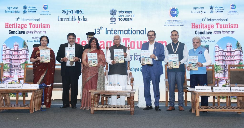 (From L to R) Shalini S Sharma, Assistant Secretary General, PHDCCI; Anil Parashar, Chair – Tourism & Hospitality Committee, PHDCCI; Urmila Shukla (IAS), Commissioner- Archaeology, Archives & Museums, Government of Madhya Pradesh; Shri Mangubhai Patel, Hon'ble Governor of Madhya Pradesh; Sanjeev Agrawal, Chair – Madhya Pradesh Chapter, PHDCCI;  Arun Srivastava, Joint Director General, Ministry of Tourism, Government of India; and Rajan Sehgal, Co-Chair – Tourism & Hospitality Committee, PHDCCI releasing the event report of 13th IHTC