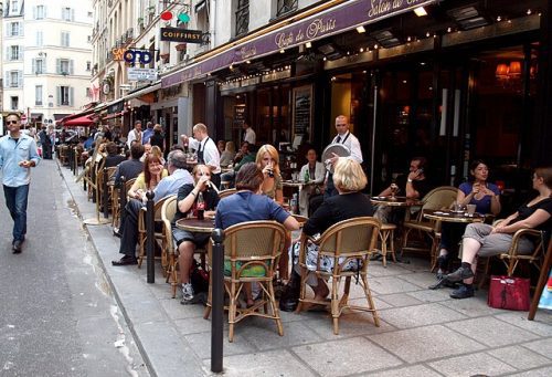 Terrace cafe, Rue de Buci, Paris, France. Image credit zoetnet via Wikipedia Commons