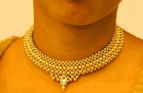 Thushi necklaces are thick chains of closely placed golden balls held together by a leather strand. Image courtesy Parekh Cards via Flickr