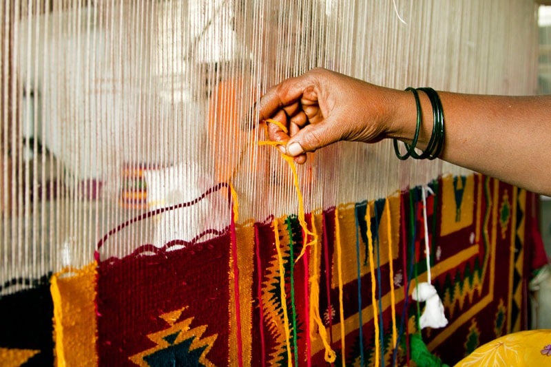 weaving Indian cotton dhurries typically involves the use of a loom